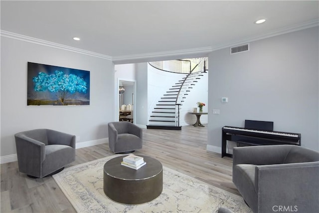 living room with ornamental molding and light wood-type flooring