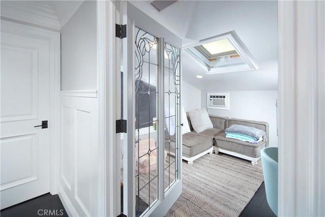 bathroom featuring an AC wall unit and hardwood / wood-style floors