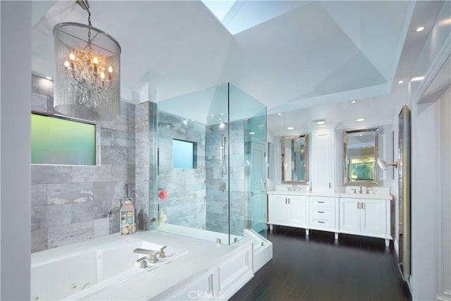 bathroom featuring lofted ceiling, hardwood / wood-style floors, vanity, independent shower and bath, and a chandelier