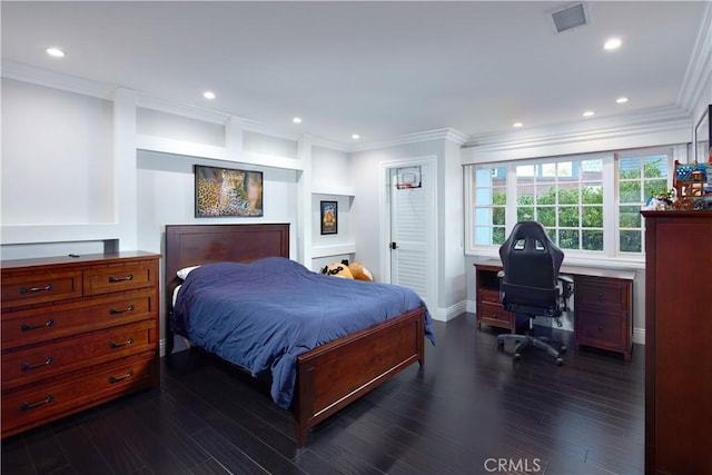 bedroom with crown molding and dark hardwood / wood-style floors