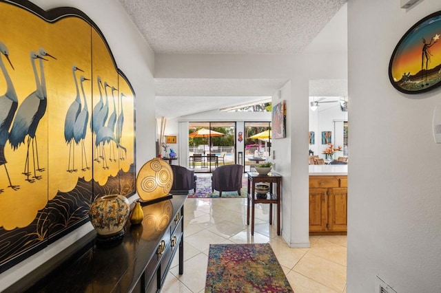 hallway with light tile patterned floors and a textured ceiling