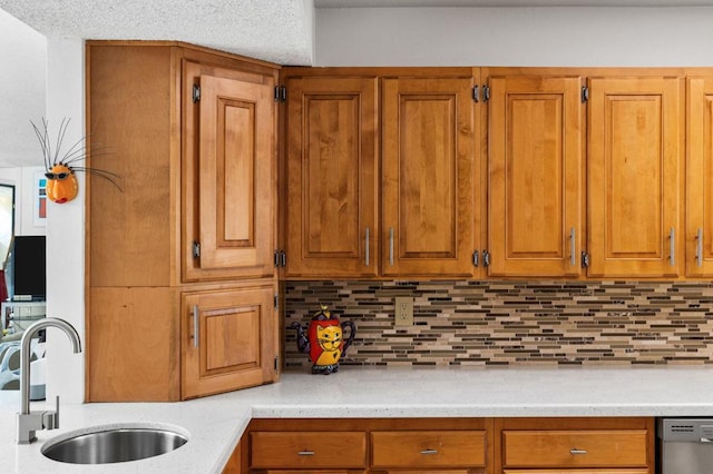 kitchen featuring sink, decorative backsplash, and dishwasher