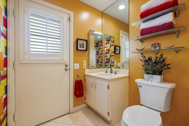 bathroom featuring tile patterned flooring, vanity, and toilet