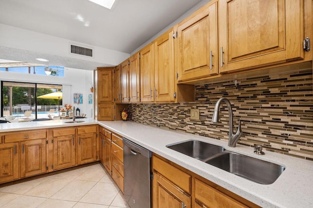 kitchen with dishwasher, sink, light tile patterned flooring, and backsplash