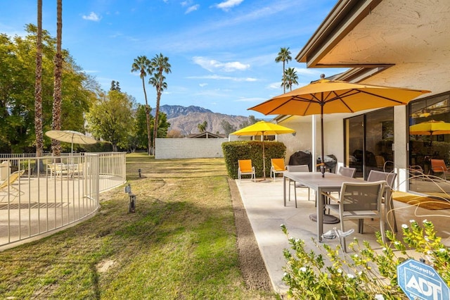 view of yard with a mountain view and a patio area