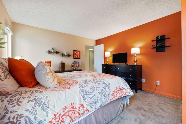 carpeted bedroom featuring a textured ceiling