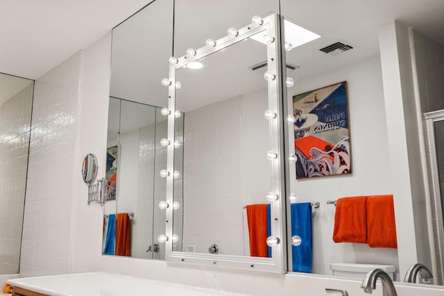 bathroom with vanity and a shower with shower door