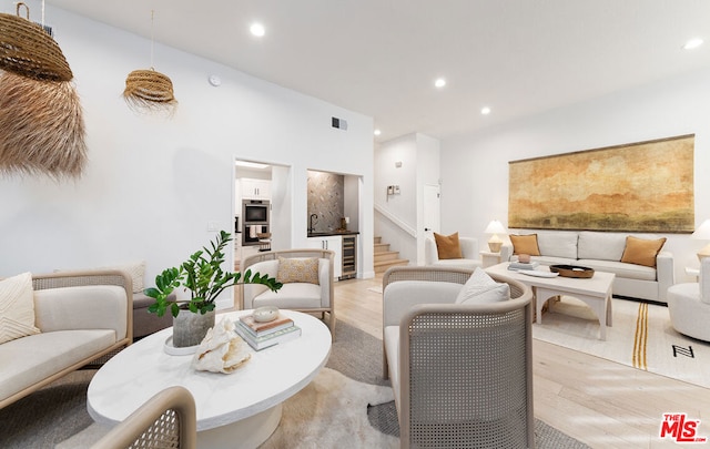 living room featuring beverage cooler and light wood-type flooring