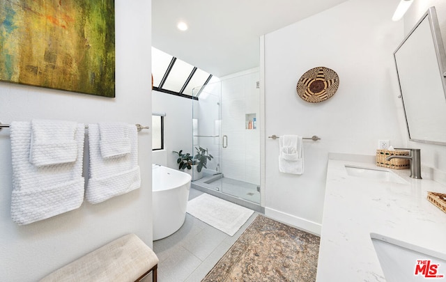 bathroom featuring vanity and independent shower and bath