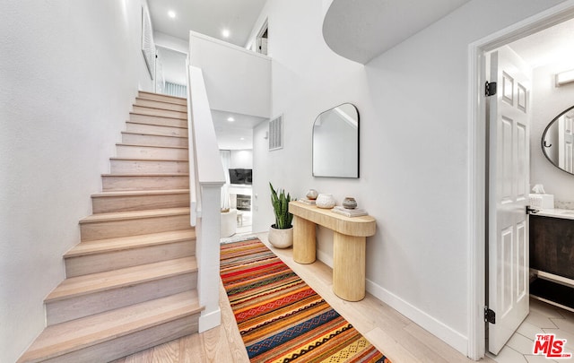 stairs featuring hardwood / wood-style flooring