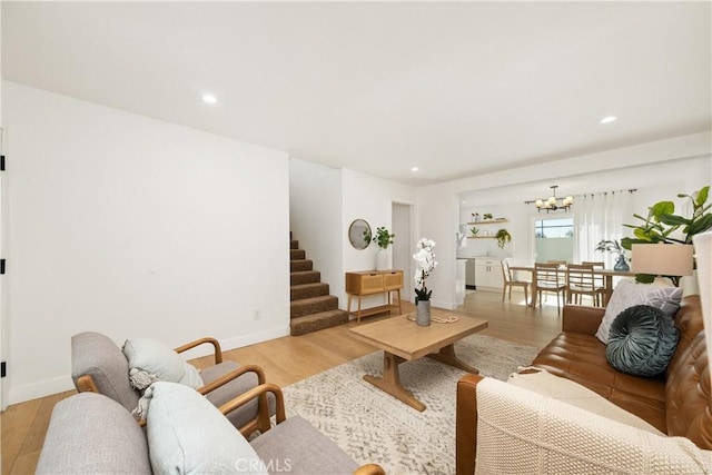 living room featuring a chandelier and light hardwood / wood-style flooring