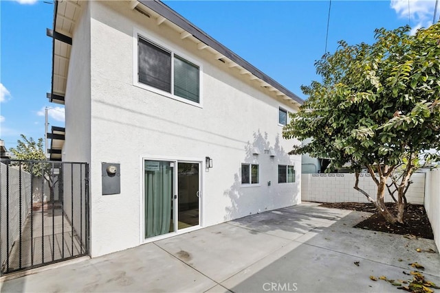 back of property with a patio