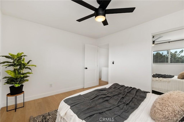 bedroom with ceiling fan and light hardwood / wood-style floors