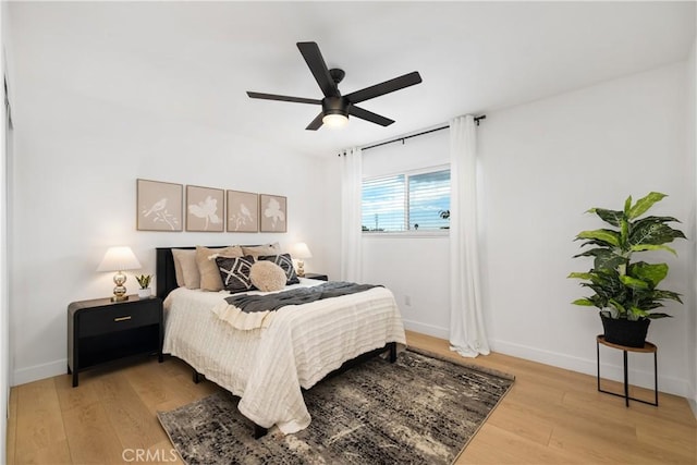 bedroom with ceiling fan and light hardwood / wood-style floors