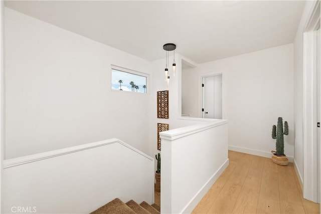 hallway with light hardwood / wood-style flooring