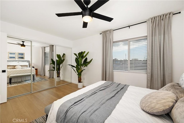 bedroom featuring ceiling fan, wood-type flooring, and a closet