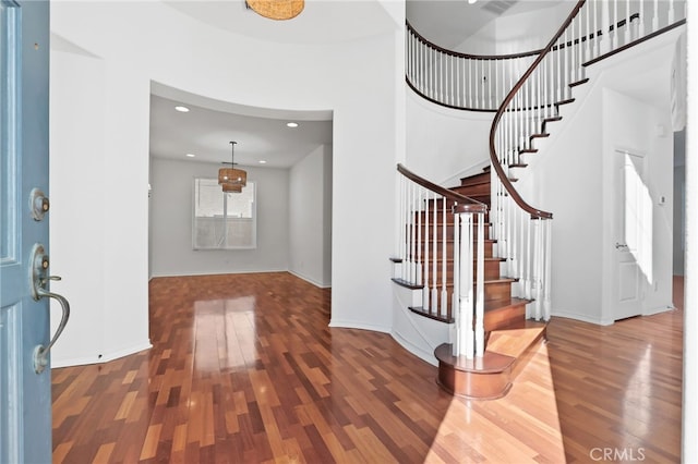 entrance foyer with stairway, recessed lighting, baseboards, and wood finished floors