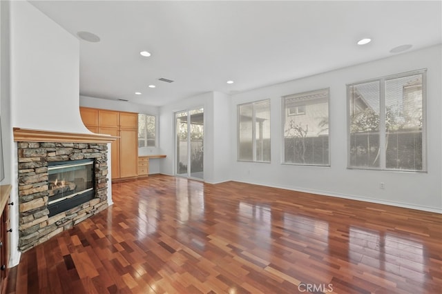 unfurnished living room with hardwood / wood-style flooring and a fireplace