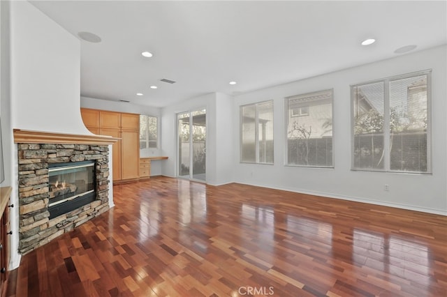 unfurnished living room with visible vents, recessed lighting, a fireplace, and wood finished floors