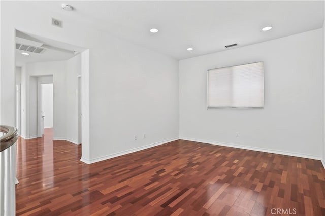 spare room featuring dark wood-type flooring