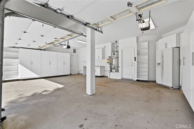 garage featuring a garage door opener and white fridge with ice dispenser