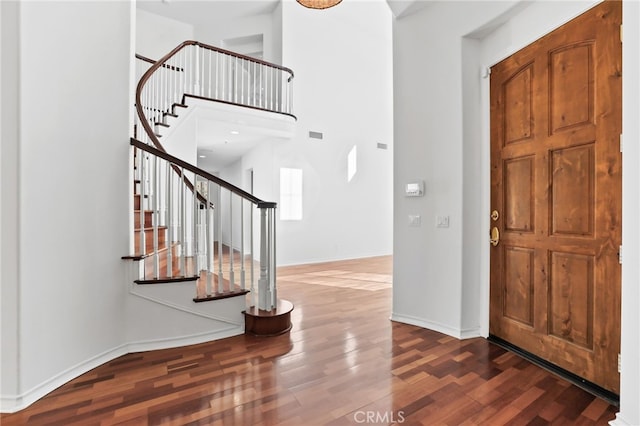 entrance foyer with hardwood / wood-style flooring and a high ceiling