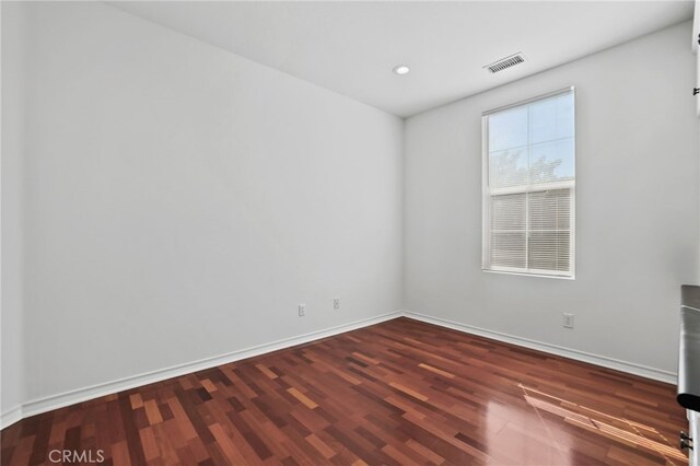 unfurnished room featuring dark wood-type flooring