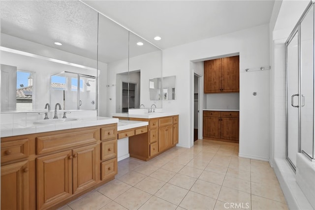 bathroom with vanity, a shower stall, recessed lighting, and tile patterned floors