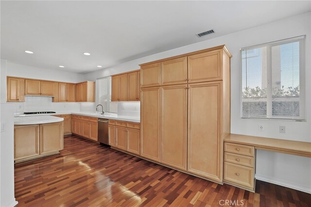 kitchen featuring built in desk, light brown cabinetry, decorative backsplash, stainless steel dishwasher, and dark wood-type flooring