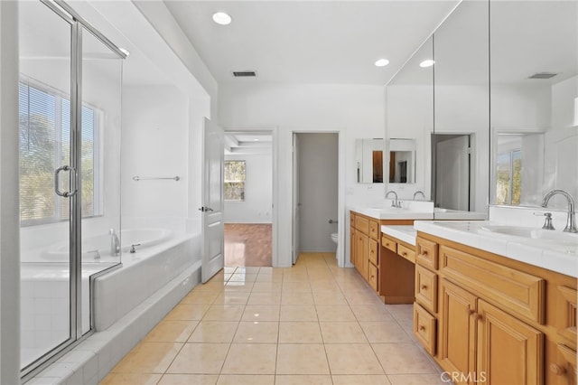 bathroom with tile patterned floors, visible vents, toilet, a sink, and double vanity