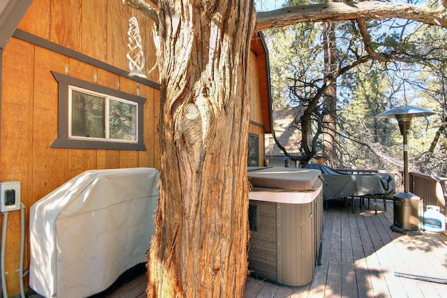 wooden deck with a hot tub