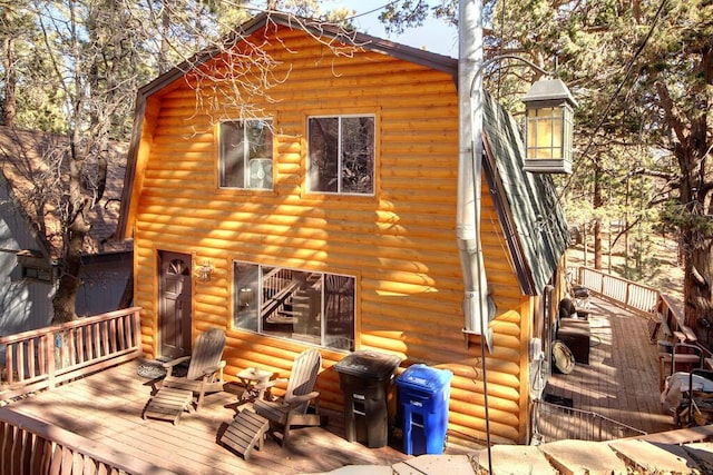 back of property featuring a wooden deck