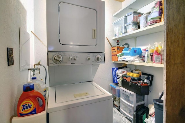 washroom featuring stacked washing maching and dryer