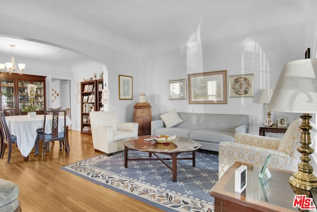 living room with an inviting chandelier and hardwood / wood-style floors