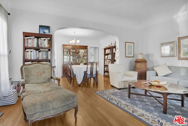 sitting room featuring light hardwood / wood-style floors and a notable chandelier