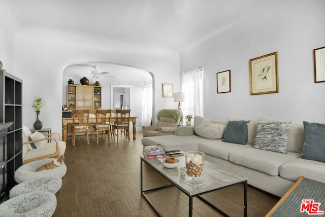 living room featuring dark hardwood / wood-style floors and ceiling fan