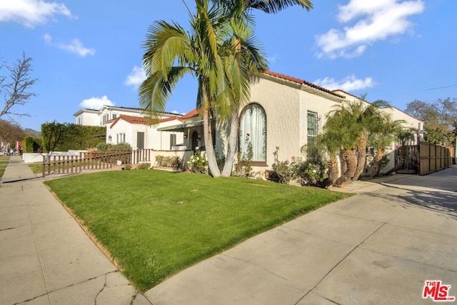 mediterranean / spanish house featuring a front yard