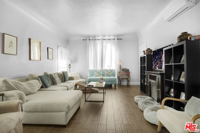 living room with dark hardwood / wood-style floors and a wall unit AC