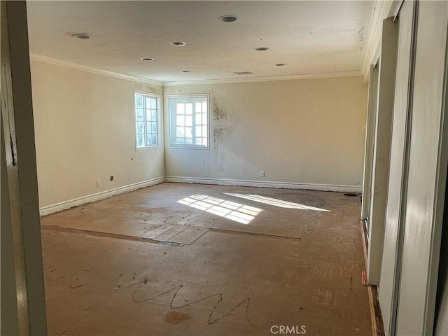 empty room featuring ornamental molding