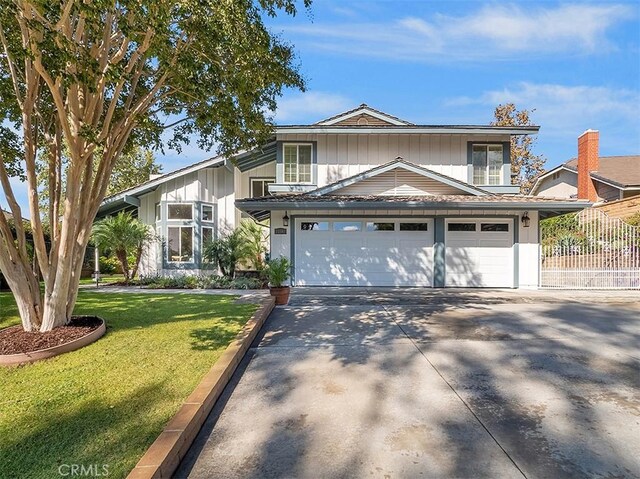 view of front of home with a garage and a front lawn