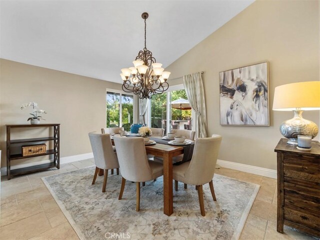 dining area featuring vaulted ceiling and a chandelier