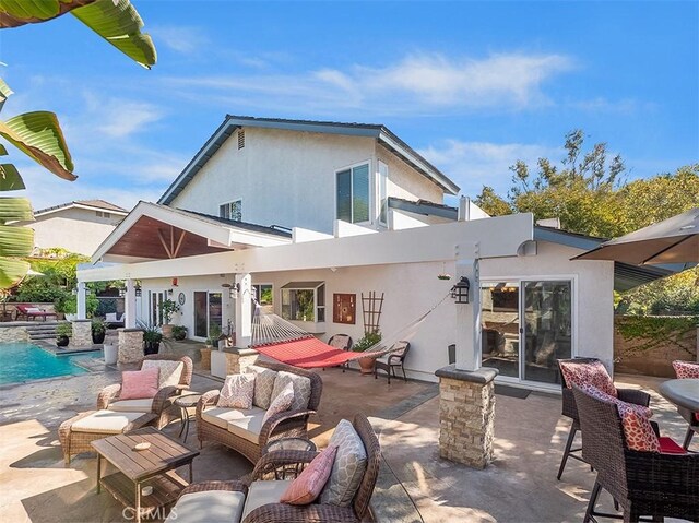 back of property featuring an outdoor hangout area and a patio