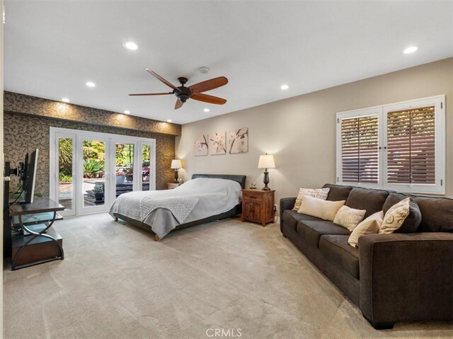 bedroom with light carpet, access to exterior, french doors, and ceiling fan