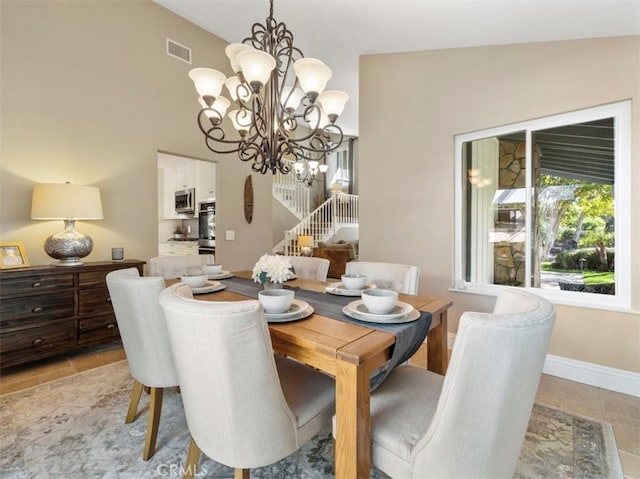 dining area with a notable chandelier and high vaulted ceiling