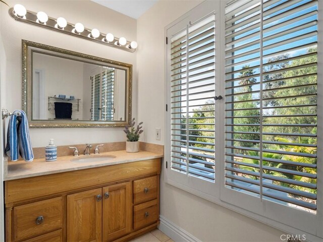 bathroom with tile patterned floors and vanity