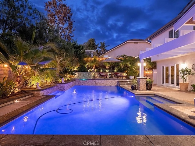 view of swimming pool featuring french doors, a hot tub, and a patio