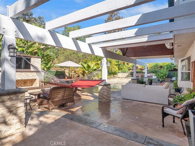 view of patio with an outdoor living space and exterior bar