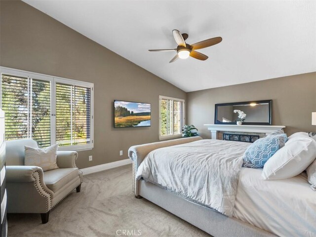 bedroom with ceiling fan, lofted ceiling, and light carpet