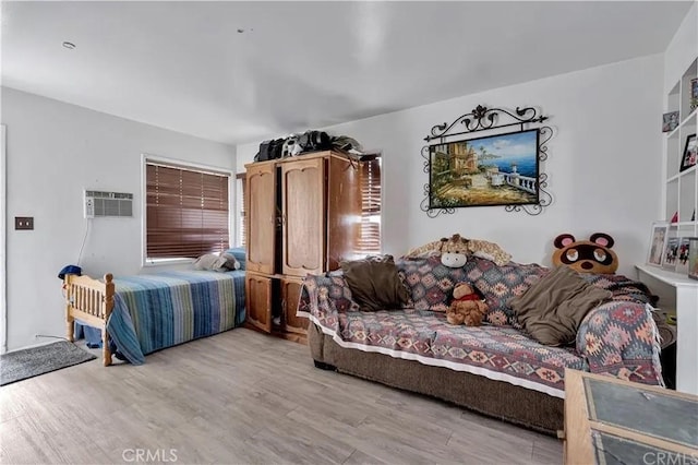 living room featuring light hardwood / wood-style floors and a wall unit AC