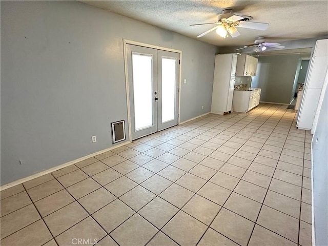 interior space featuring white cabinetry, light tile patterned floors, ceiling fan, a textured ceiling, and french doors